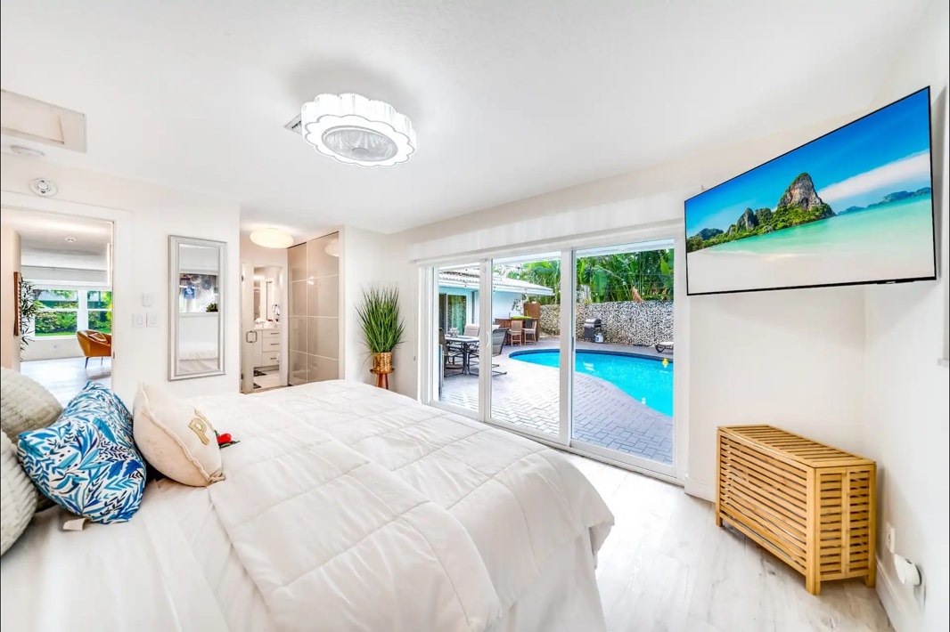 Tiki Sunset Home bright bedroom overlooking the pool