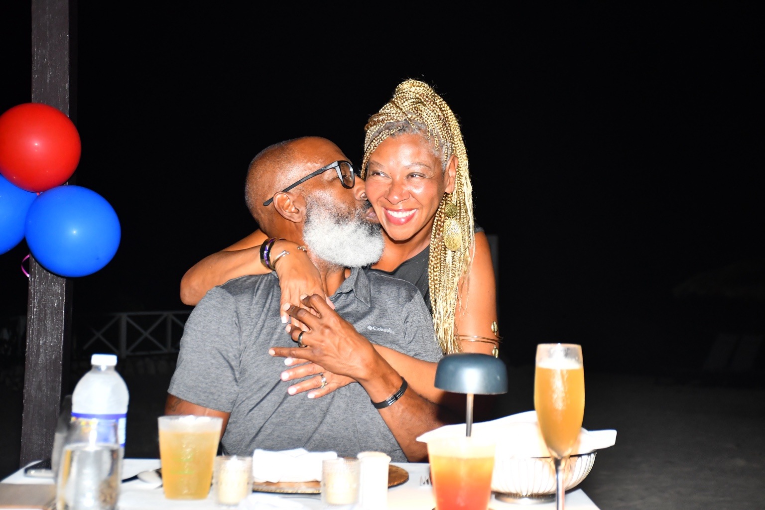 Robert kisses Brigette on the cheek during their anniversary dinner date in Negril, Jamaica