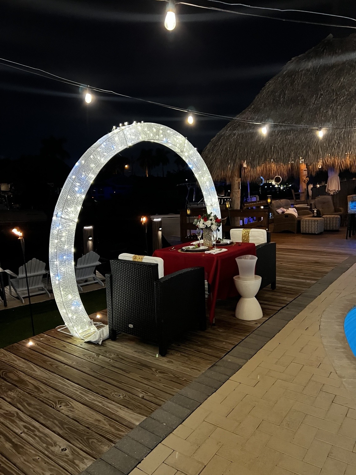 A glowing circular arch and a table for two turn the waterfront into a private little world.